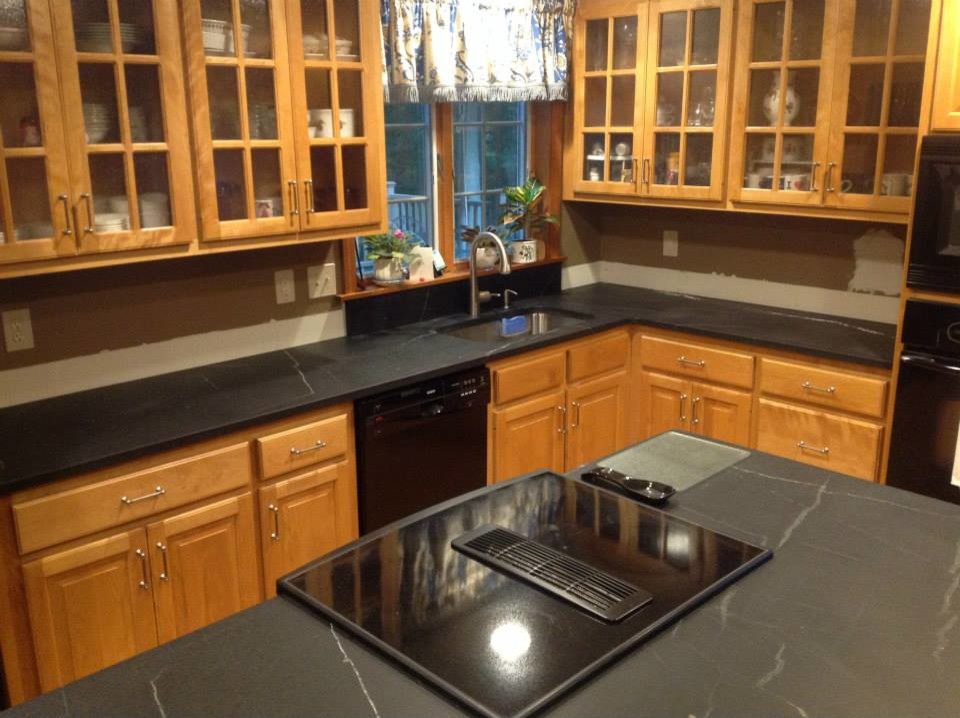 Mid-sized l-shaped open concept kitchen photo in Bridgeport with a drop-in sink, raised-panel cabinets, light wood cabinets, black appliances and an island