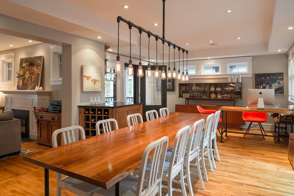 This is an example of a large contemporary open plan dining in Ottawa with grey walls, light hardwood floors and no fireplace.