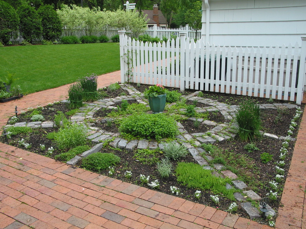 Photo of a mid-sized traditional backyard garden in Minneapolis with brick pavers.