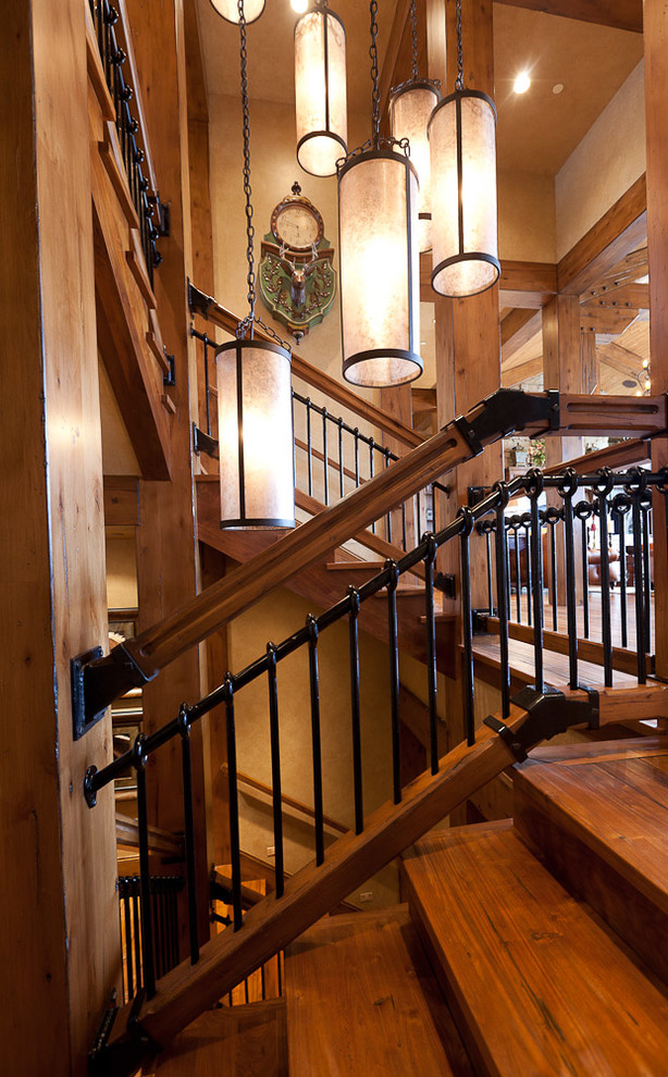 This is an example of a large arts and crafts wood u-shaped staircase in Salt Lake City with wood risers.