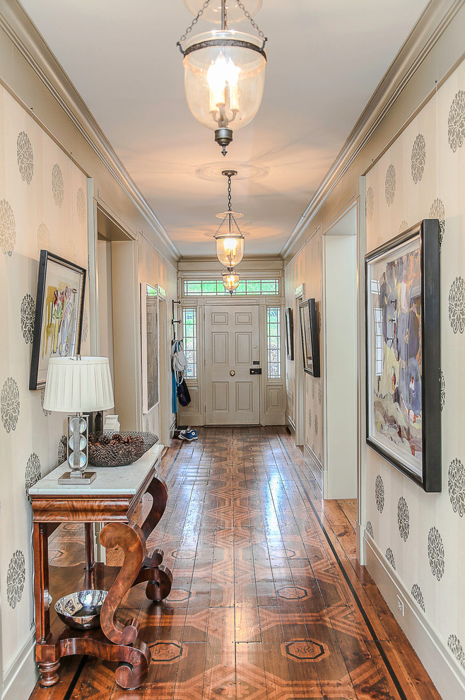 This is an example of a mid-sized traditional hallway in New York with painted wood floors and beige walls.