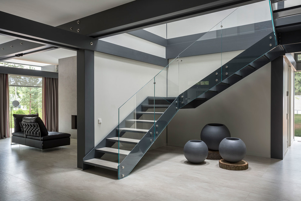 This is an example of a large contemporary l-shaped staircase in Moscow with glass railing and open risers.