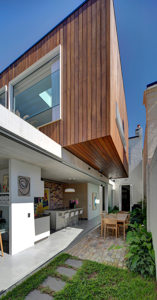 Inspiration for a mid-sized contemporary two-storey exterior in Sydney with mixed siding.