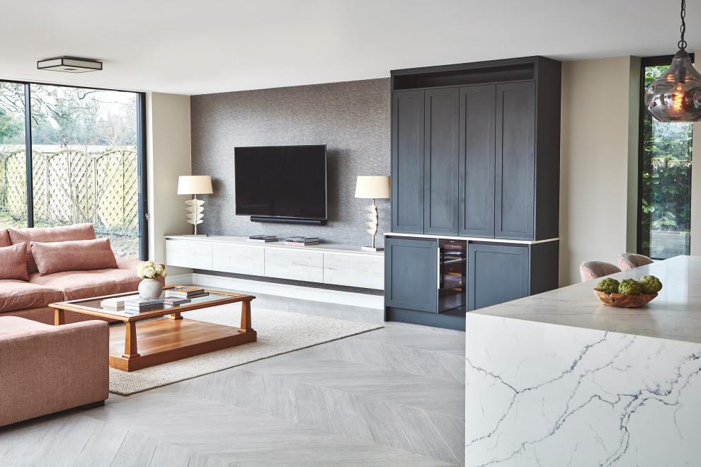 Photo of a large modern open plan living room feature wall in Hampshire with a home bar, beige walls, no fireplace, a wall mounted tv and wallpapered walls.