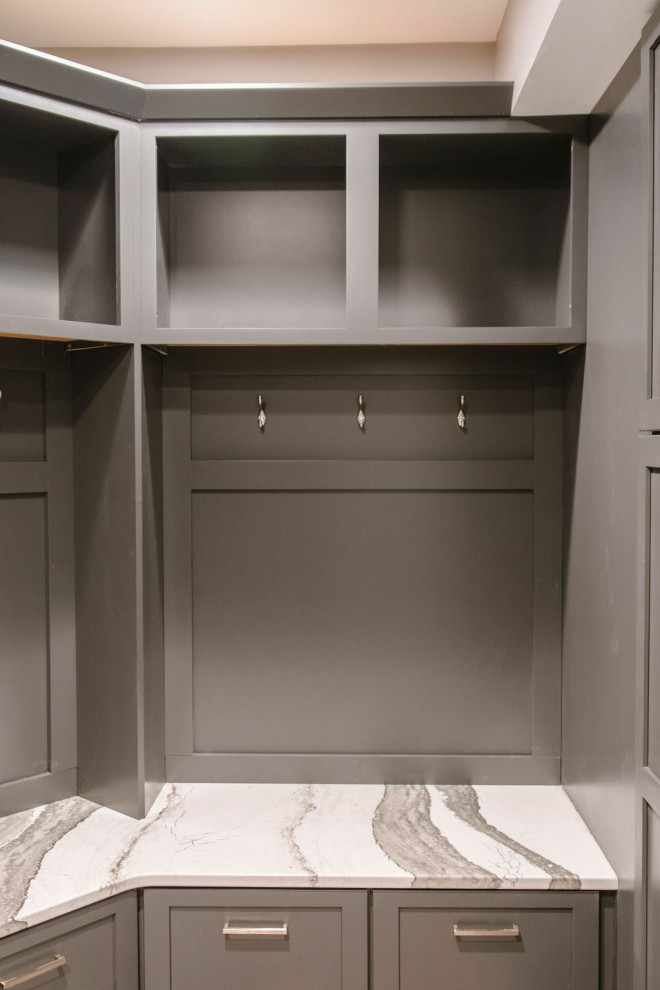 Inspiration for a mid-sized contemporary mudroom in Omaha with grey walls, marble floors and grey floor.