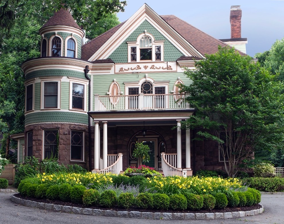 Inspiration for a large victorian green two-story mixed siding landscaping in New York with a hip roof.