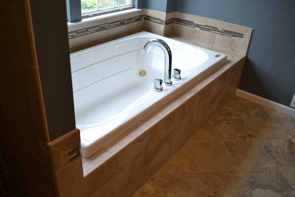 Inspiration for a mid-sized traditional master bathroom in Wilmington with an undermount sink, recessed-panel cabinets, dark wood cabinets, engineered quartz benchtops, a drop-in tub, a corner shower, a two-piece toilet, beige tile, porcelain tile, blue walls and porcelain floors.
