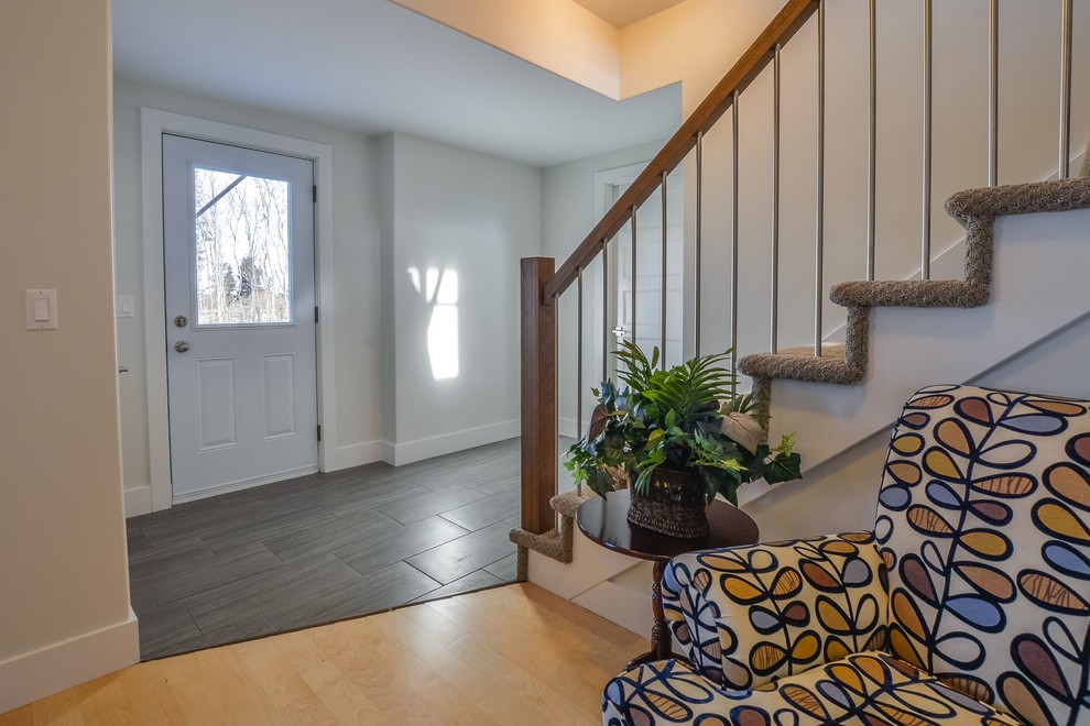 Front door - transitional beige floor front door idea with white walls and a white front door