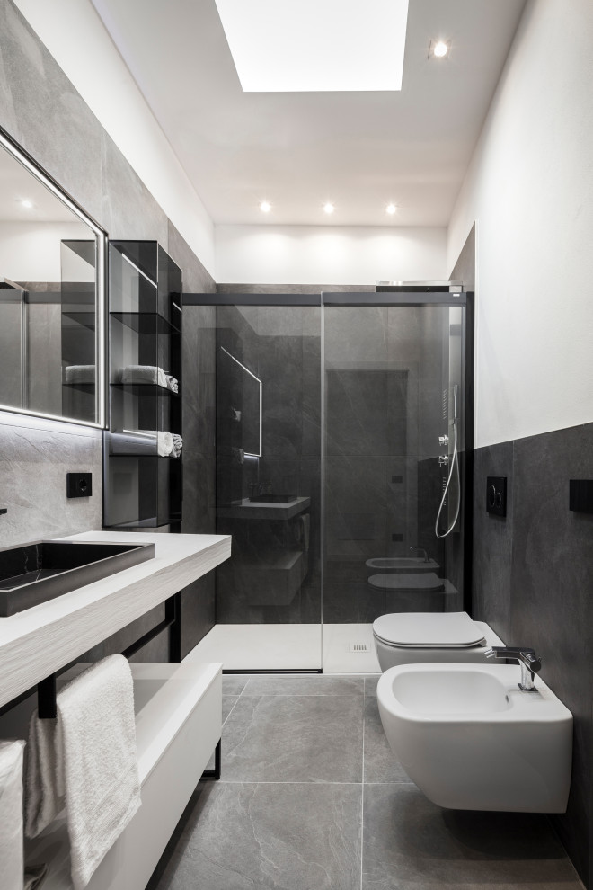 Inspiration for a mid-sized contemporary 3/4 bathroom in Other with open cabinets, grey cabinets, a curbless shower, a wall-mount toilet, gray tile, porcelain tile, white walls, porcelain floors, an integrated sink, laminate benchtops, grey floor, a sliding shower screen, grey benchtops, a single vanity and a floating vanity.