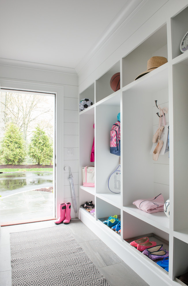 This is an example of a country mudroom in New York with white walls.