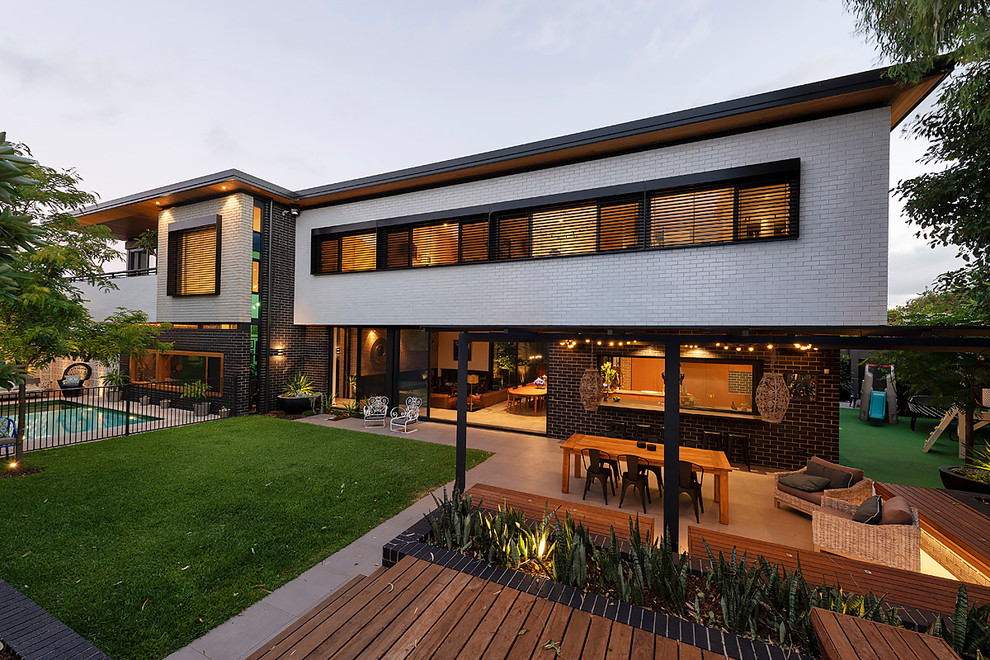 Large midcentury two-storey brick house exterior in Perth with a flat roof.