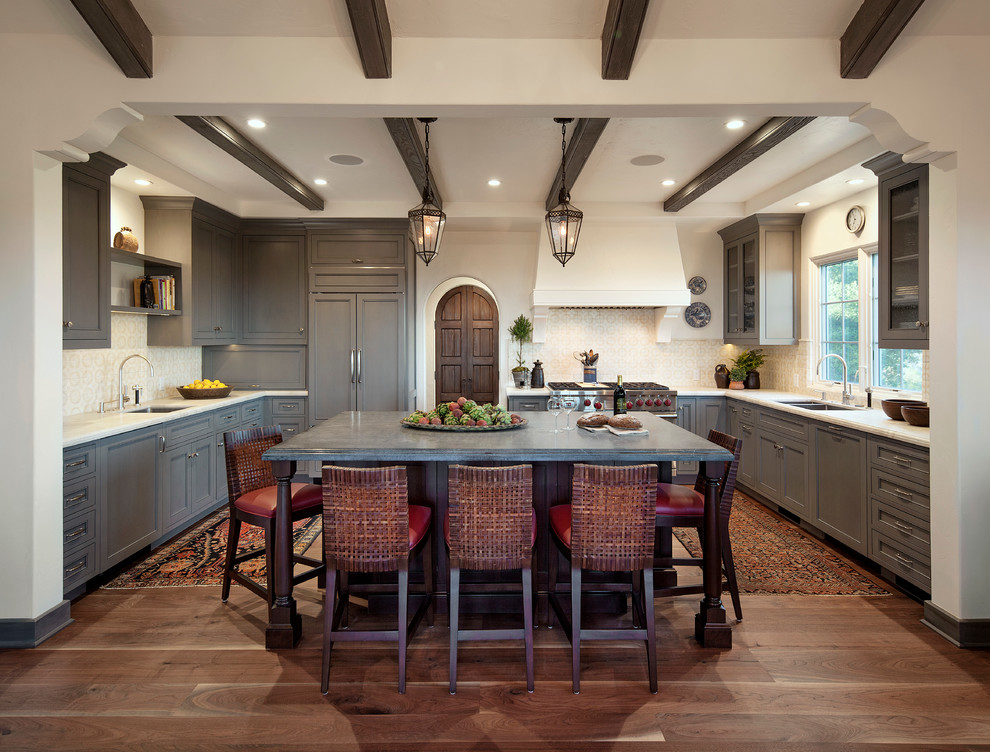 This is an example of a mid-sized mediterranean u-shaped eat-in kitchen in Santa Barbara with an undermount sink, shaker cabinets, grey cabinets, quartzite benchtops, beige splashback, ceramic splashback, panelled appliances, dark hardwood floors and with island.