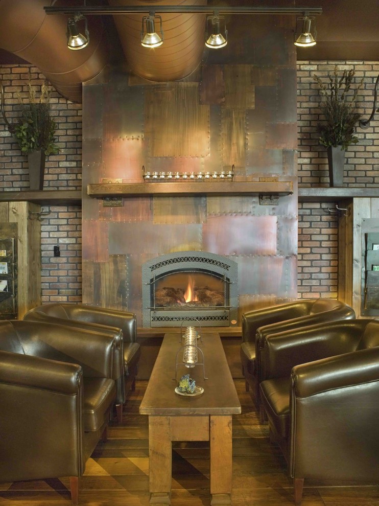 Inspiration for a country living room in Denver with a standard fireplace and a metal fireplace surround.