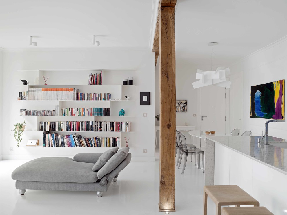 Photo of a large contemporary open concept living room in Other with a library, white walls, concrete floors and a wall-mounted tv.