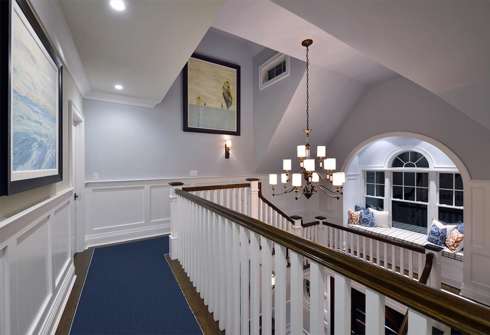 Large traditional hallway in New York with blue walls, carpet and blue floor.