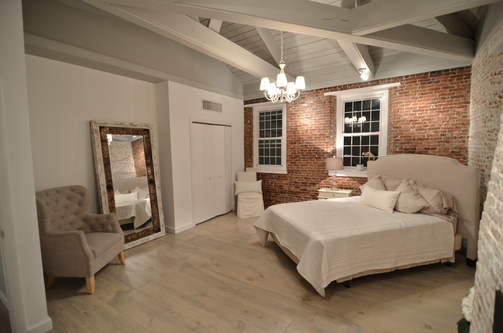 Inspiration for a mid-sized country guest bedroom in Boston with red walls, light hardwood floors, no fireplace and beige floor.