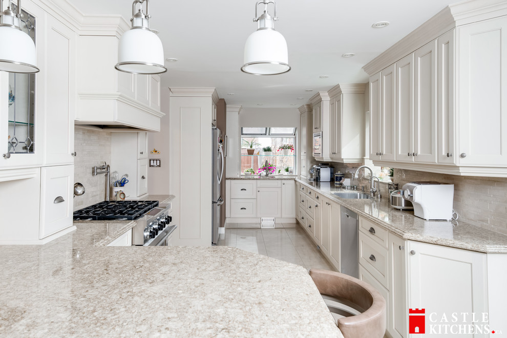 Inspiration for a mid-sized transitional galley porcelain tile enclosed kitchen remodel in Toronto with an undermount sink, shaker cabinets, beige cabinets, quartzite countertops, beige backsplash, stainless steel appliances and an island