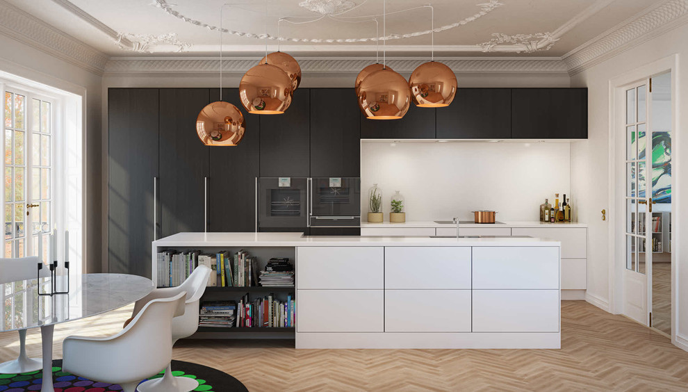 Inspiration for a large contemporary galley eat-in kitchen in Aalborg with flat-panel cabinets, black cabinets, black appliances, light hardwood floors, with island and a drop-in sink.