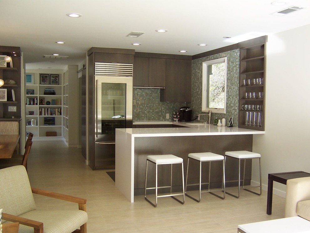Photo of a contemporary kitchen in San Francisco with mosaic tile splashback, grey splashback, stainless steel appliances, flat-panel cabinets and dark wood cabinets.
