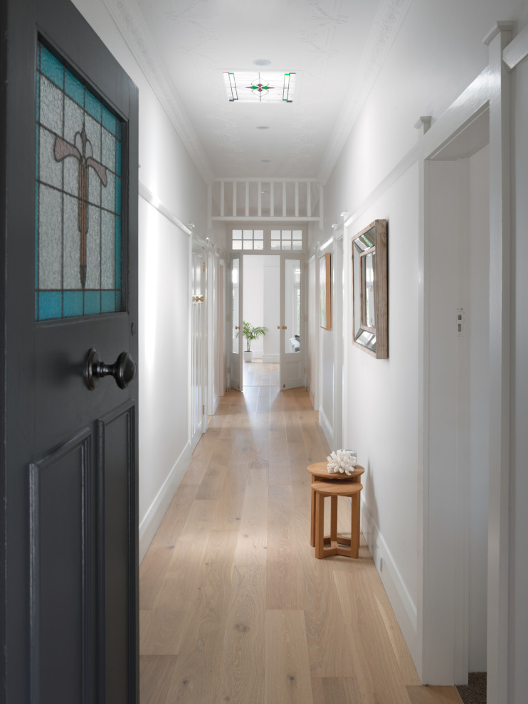 Design ideas for a large transitional entry hall in Sydney with yellow walls, light hardwood floors, a single front door, a gray front door and beige floor.
