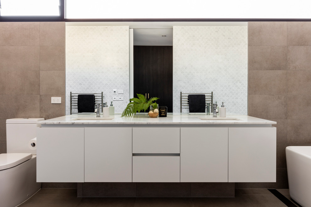 Mid-sized contemporary 3/4 bathroom in Sydney with furniture-like cabinets, light wood cabinets, brown tile, porcelain tile and terrazzo benchtops.