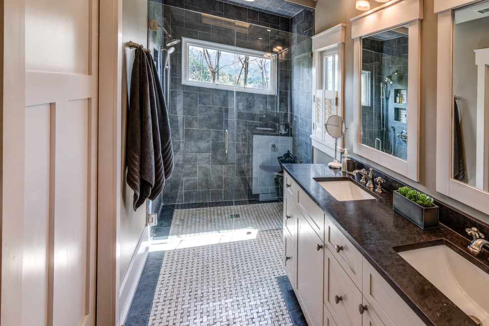 This is an example of a small modern master bathroom in Other with shaker cabinets, white cabinets, a curbless shower, black tile, slate, beige walls, ceramic floors, an undermount sink, soapstone benchtops, multi-coloured floor, a hinged shower door and black benchtops.