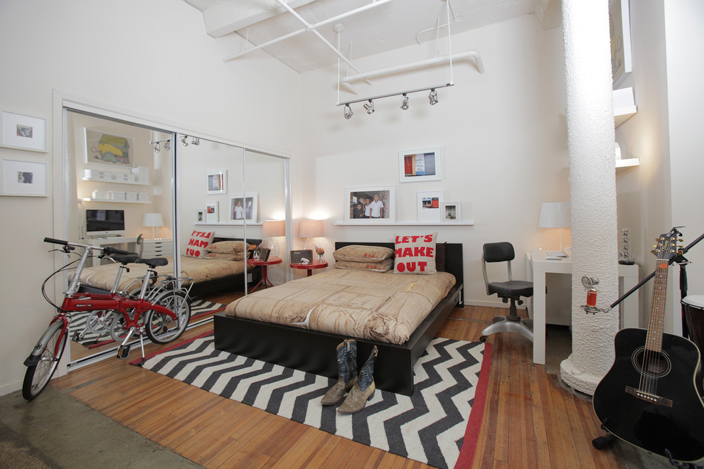 Inspiration for an eclectic bedroom in Dallas with white walls and medium hardwood floors.