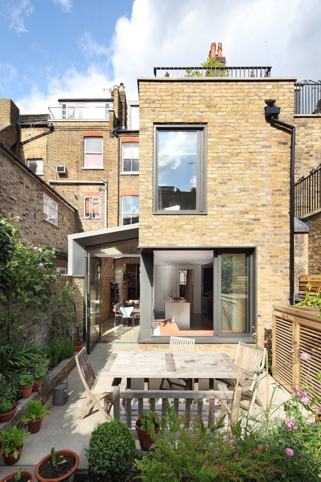 Design ideas for a contemporary two-storey exterior in London with stone veneer.