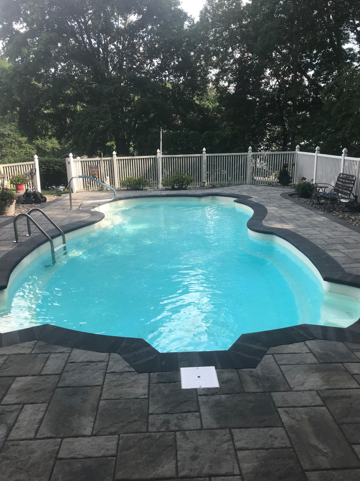 Pool - mid-sized transitional concrete paver pool idea
