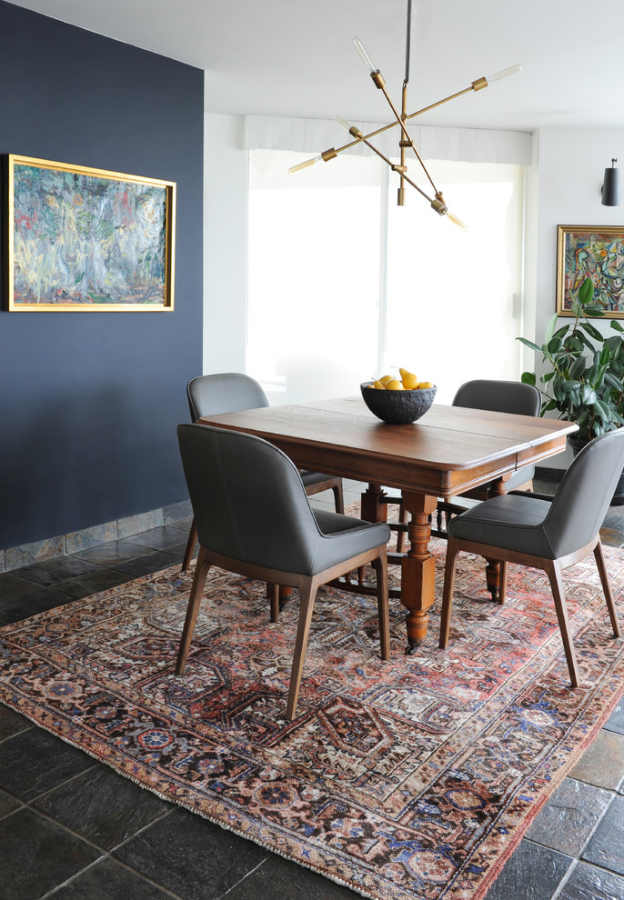Design ideas for a small transitional open plan dining in Vancouver with white walls and slate floors.