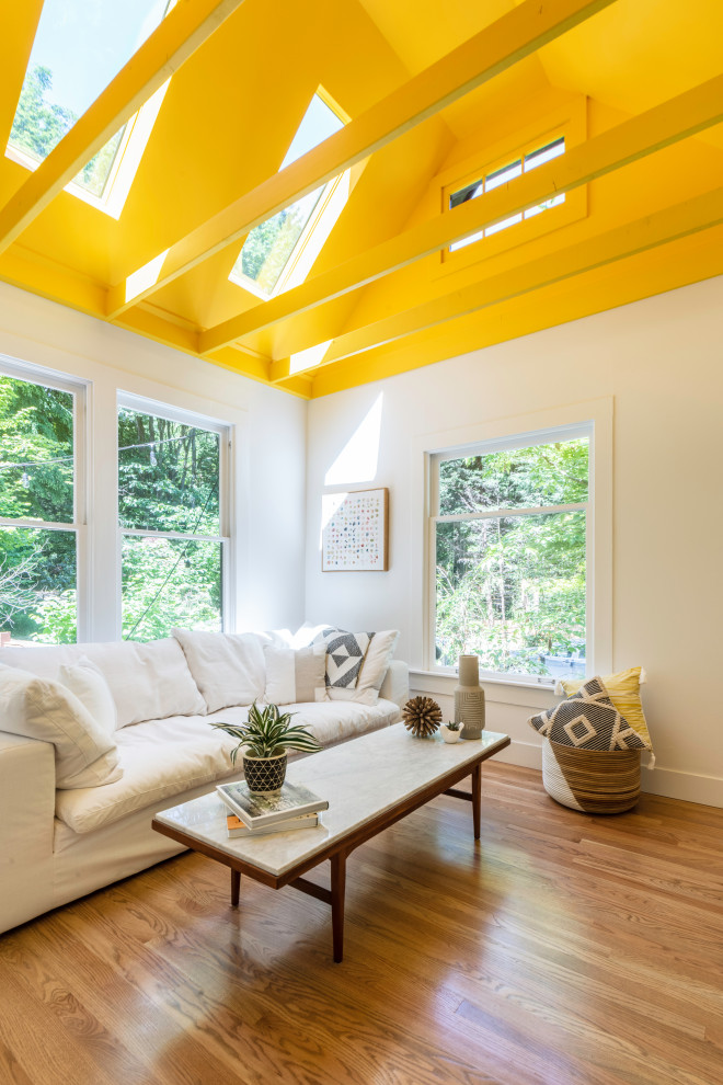 Living room - contemporary medium tone wood floor, brown floor, exposed beam and vaulted ceiling living room idea in Seattle with white walls