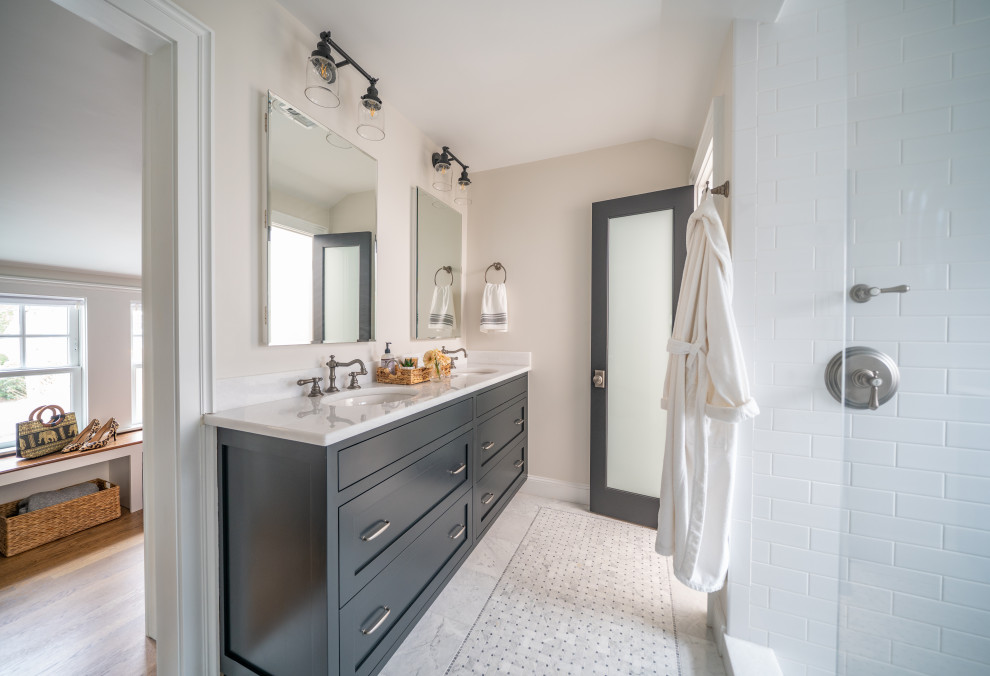 Inspiration for a mid-sized transitional master bathroom in Boston with shaker cabinets, white tile, ceramic tile, an undermount sink, white benchtops, black cabinets, marble floors, marble benchtops, grey floor, an open shower, an alcove shower, beige walls and a double vanity.