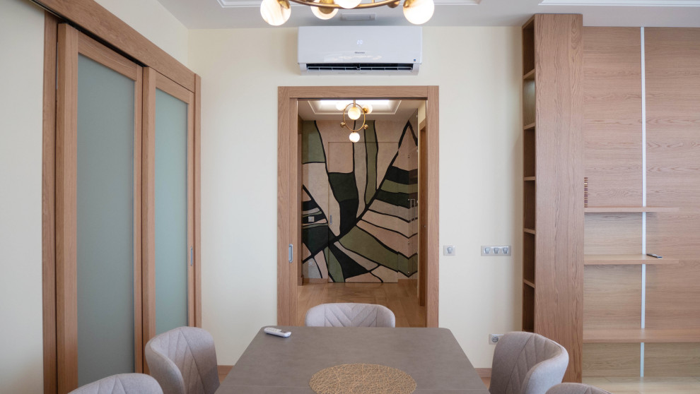 This is an example of a large contemporary separate dining room in Moscow with beige walls, medium hardwood floors and recessed.