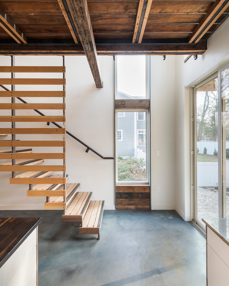 Industrial wood straight staircase in Providence with open risers and metal railing.