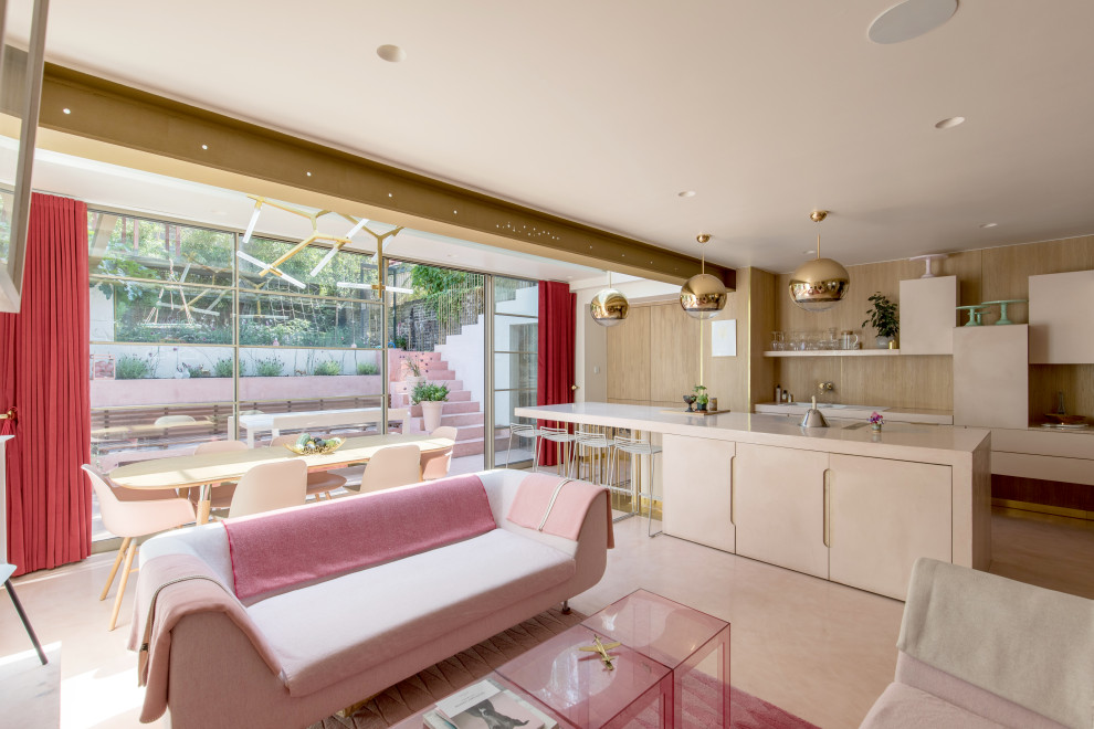 Photo of a large modern open concept living room in London with concrete floors, a metal fireplace surround and pink floor.
