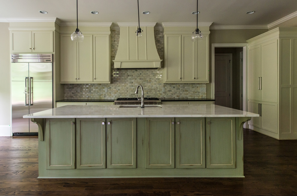 Inspiration for a large traditional l-shaped eat-in kitchen in Atlanta with a double-bowl sink, shaker cabinets, marble benchtops, multi-coloured splashback, subway tile splashback, stainless steel appliances, medium hardwood floors, with island and green cabinets.