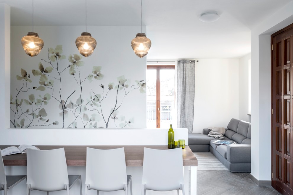 Large contemporary open plan dining in Milan with porcelain floors and grey floor.
