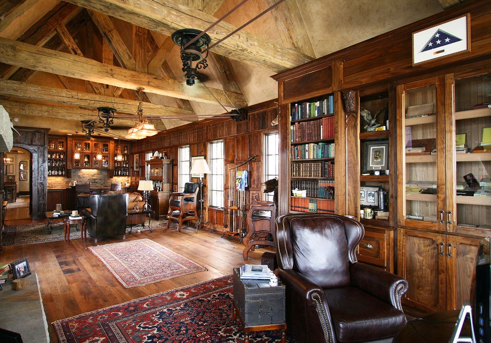 Inspiration for a large traditional home bar in Charlotte with dark hardwood floors.