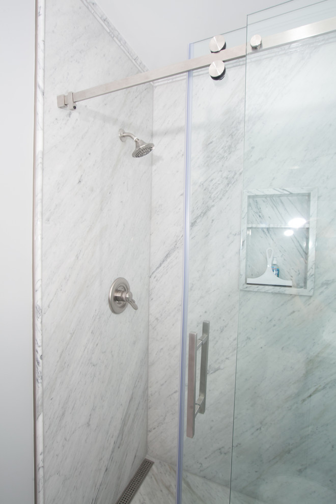Alcove shower - mid-sized transitional master multicolored tile and stone slab marble floor and multicolored floor alcove shower idea with raised-panel cabinets, gray cabinets, a two-piece toilet, blue walls, an integrated sink, solid surface countertops and white countertops