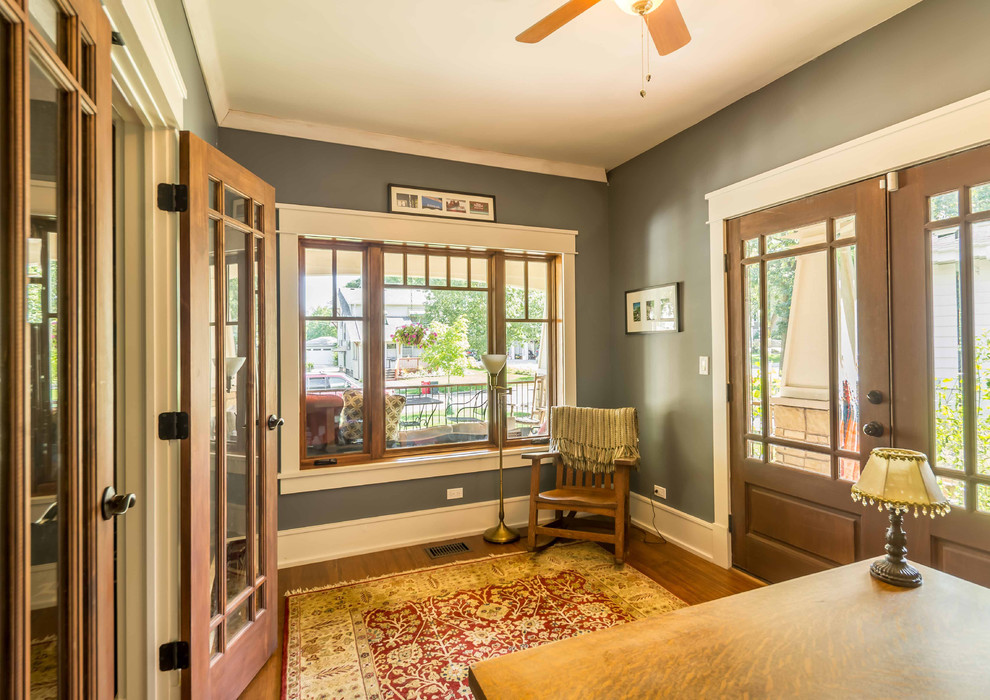 Mid-sized arts and crafts foyer in Chicago with grey walls, medium hardwood floors, a double front door, a medium wood front door, brown floor, recessed and wallpaper.