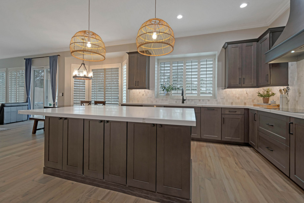 Large porcelain tile and brown floor eat-in kitchen photo in Phoenix with an undermount sink, shaker cabinets, quartz countertops, multicolored backsplash, marble backsplash, stainless steel appliances, an island and white countertops