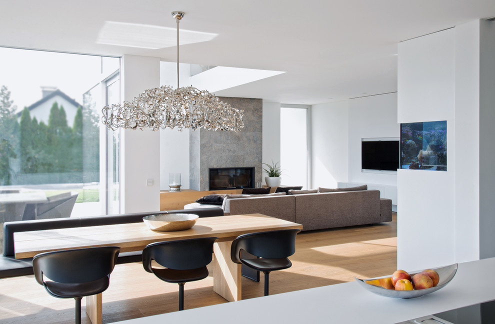 Design ideas for a modern open plan dining in Stuttgart with white walls and light hardwood floors.