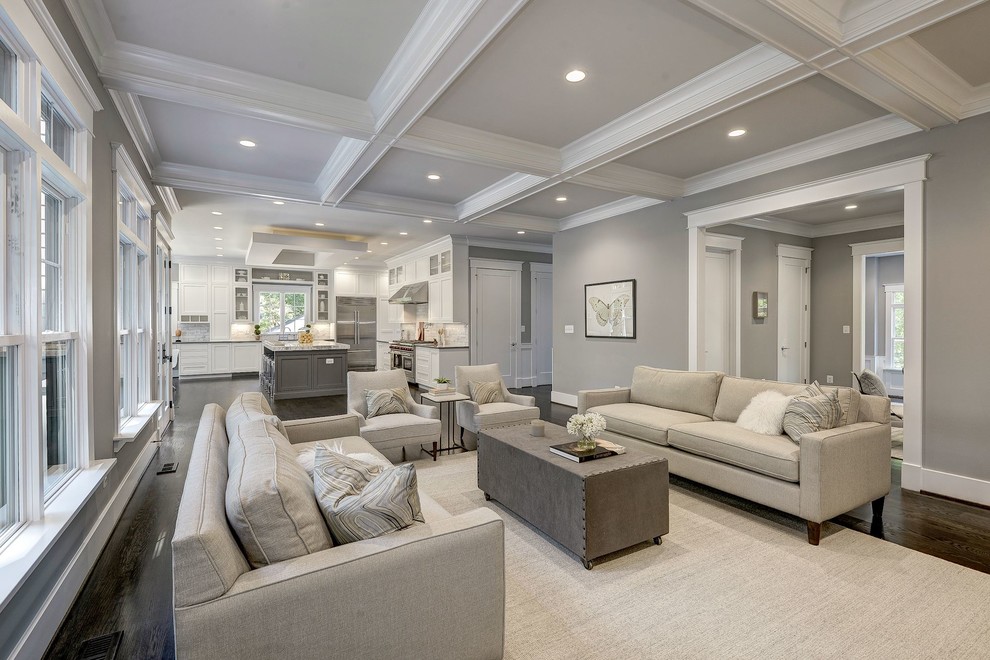 This is an example of a large contemporary open concept family room in DC Metro with grey walls, dark hardwood floors, a standard fireplace, a plaster fireplace surround, a wall-mounted tv and brown floor.