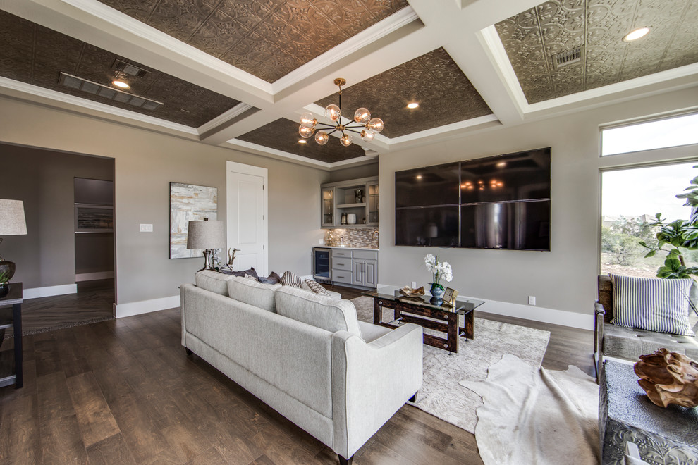 Inspiration for a mid-sized transitional open concept home theatre in Dallas with grey walls, medium hardwood floors, a wall-mounted tv and brown floor.
