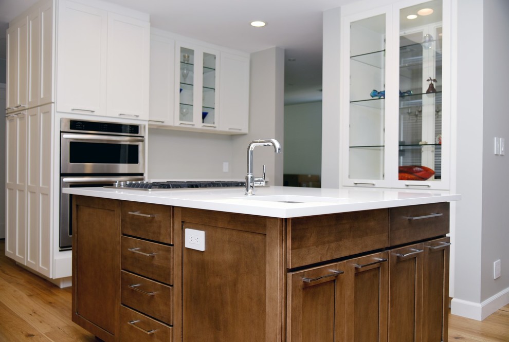 Example of a large transitional eat-in kitchen design in Los Angeles with an undermount sink, shaker cabinets, quartz countertops, stainless steel appliances, two islands and white cabinets