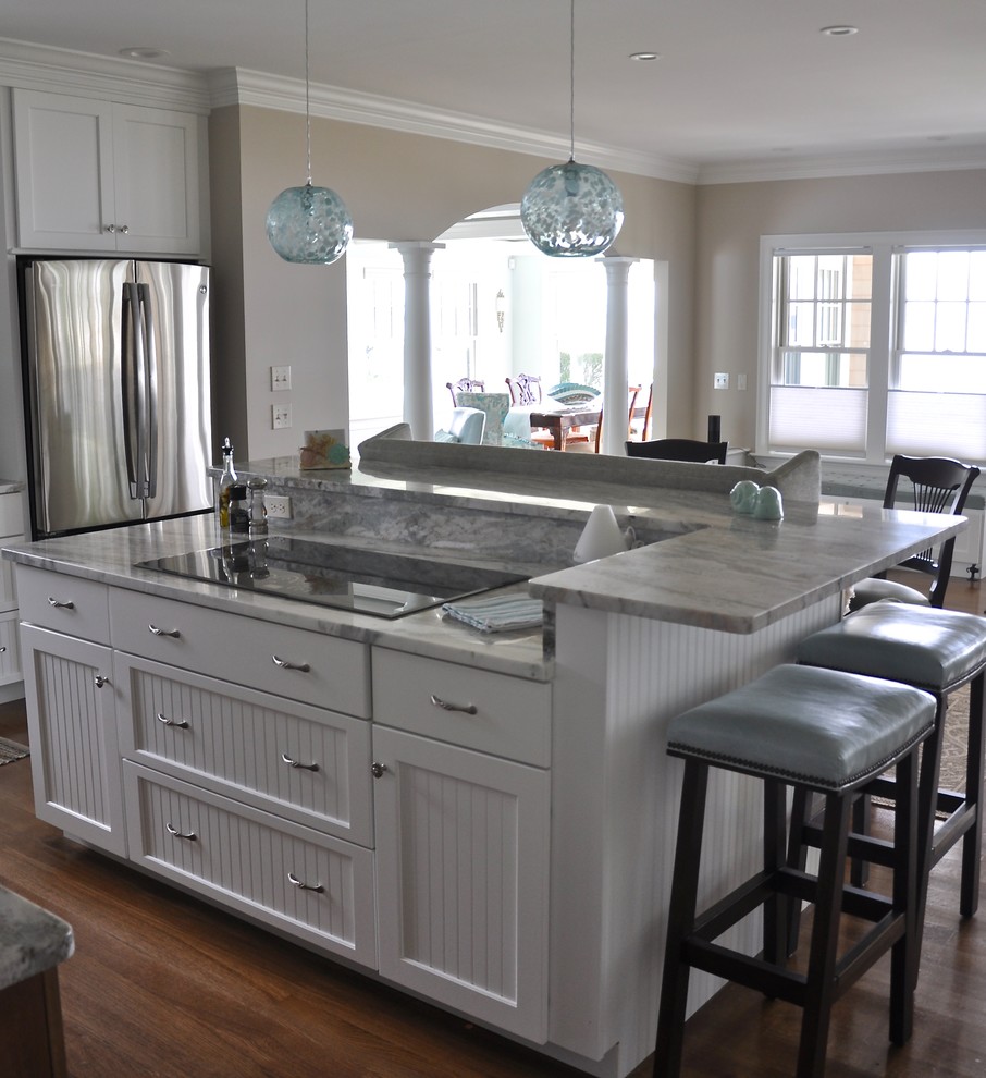 Inspiration for an expansive beach style eat-in kitchen in Providence with a single-bowl sink, recessed-panel cabinets, white cabinets, quartzite benchtops, blue splashback, glass tile splashback, stainless steel appliances, dark hardwood floors, with island and beige floor.