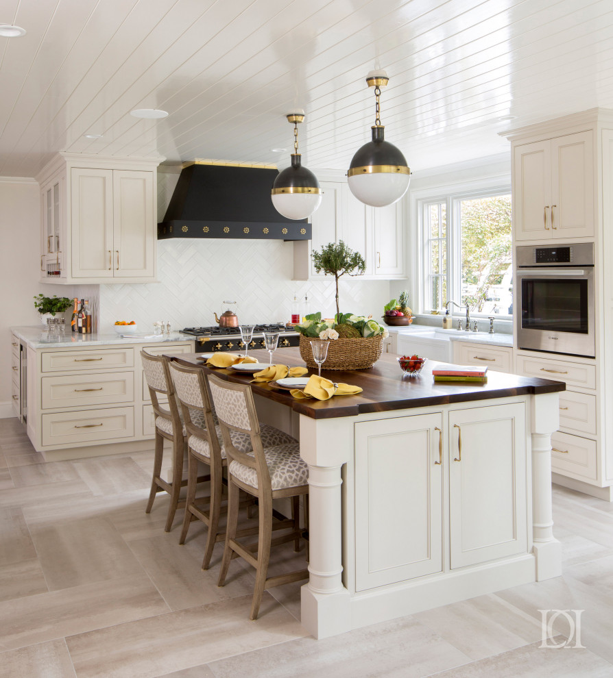 Inspiration for a large traditional u-shaped eat-in kitchen in Philadelphia with a farmhouse sink, beaded inset cabinets, grey cabinets, quartzite benchtops, white splashback, subway tile splashback, coloured appliances, porcelain floors, with island, grey floor and white benchtop.