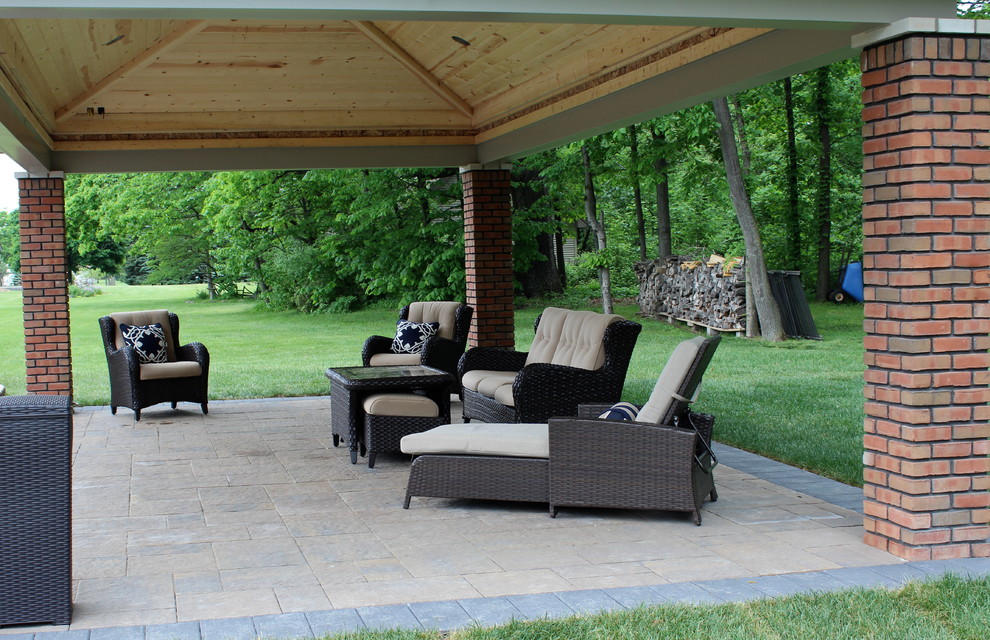 Photo of a mid-sized contemporary backyard patio in Detroit with tile and a gazebo/cabana.