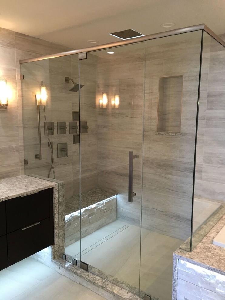 Large contemporary master bathroom in Orlando with flat-panel cabinets, dark wood cabinets, a drop-in tub, a double shower, white tile, porcelain tile, porcelain floors, an undermount sink and engineered quartz benchtops.