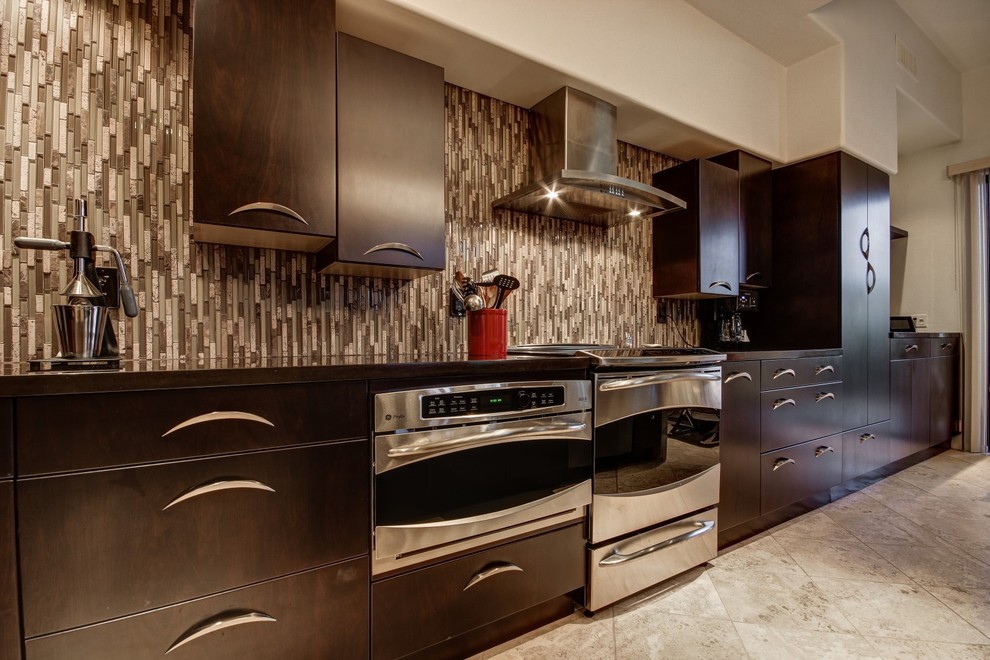 This is an example of a mid-sized contemporary l-shaped eat-in kitchen in Phoenix with an undermount sink, flat-panel cabinets, dark wood cabinets, quartz benchtops, multi-coloured splashback, glass tile splashback, stainless steel appliances, with island, beige floor and grey benchtop.